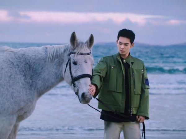 于适牵着白马Spydar在七英里海滩（Seven Mile Beach）