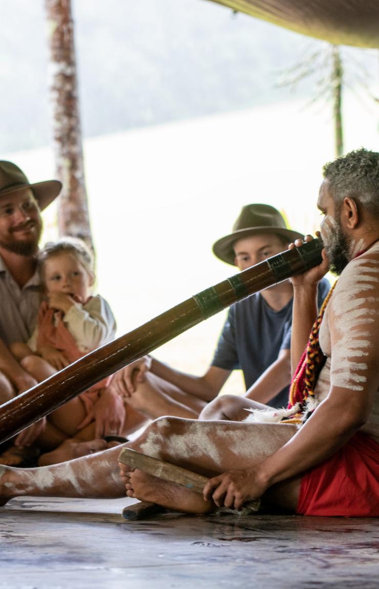 一家人在热带雨林自然公园一起观看迪吉里杜管表演 © 昆士兰州旅游及活动推广局版权所有