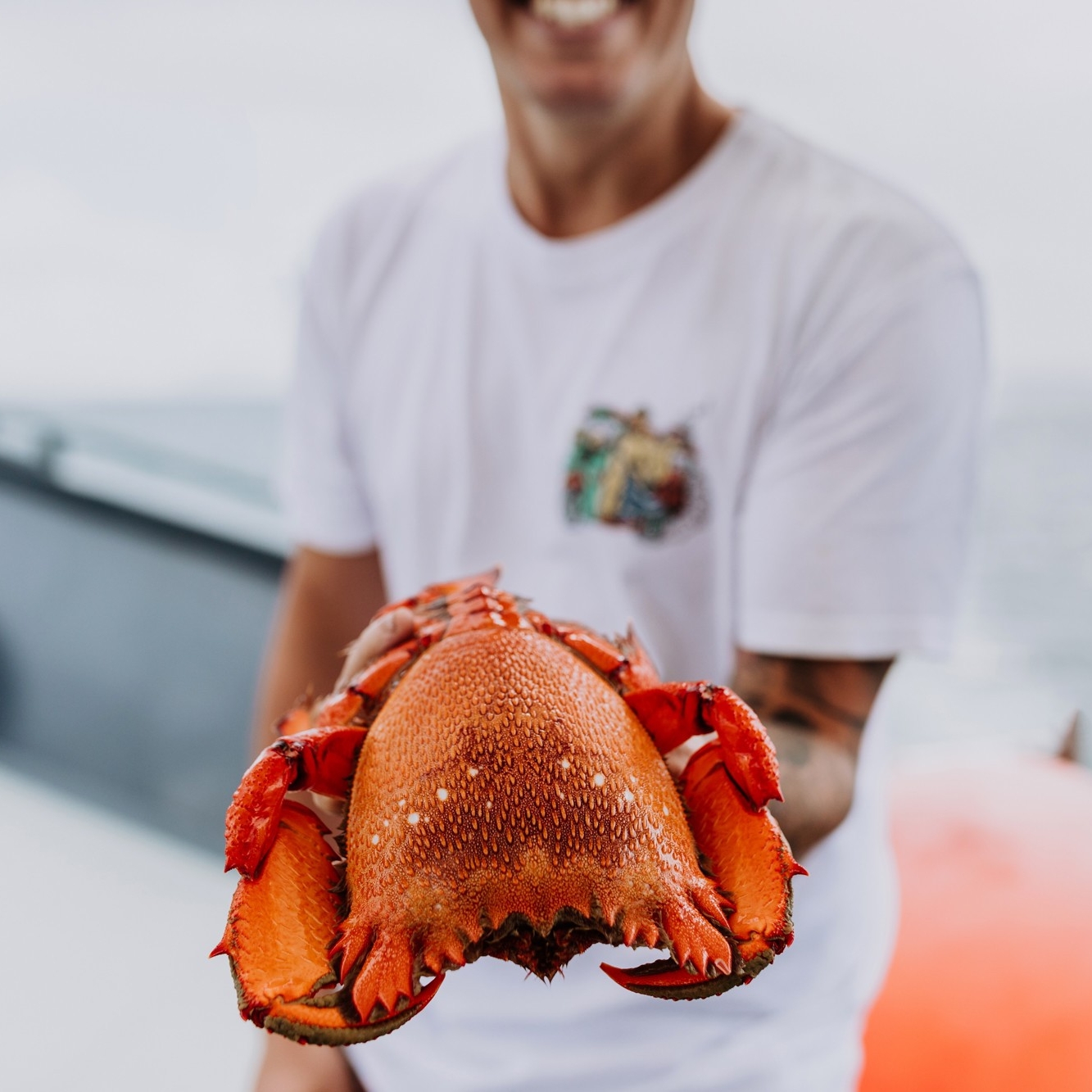 在莫罗拉巴一位男士手里抓着新捕获的旭蟹 © 昆士兰州旅游及活动推广局版权所有